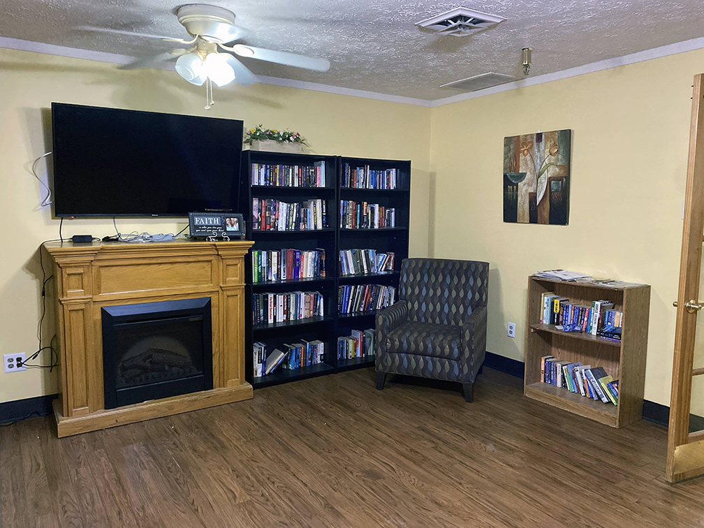 Brickyard Healthcare Churchman Care Center fireplace, TV, and bookcases for residents