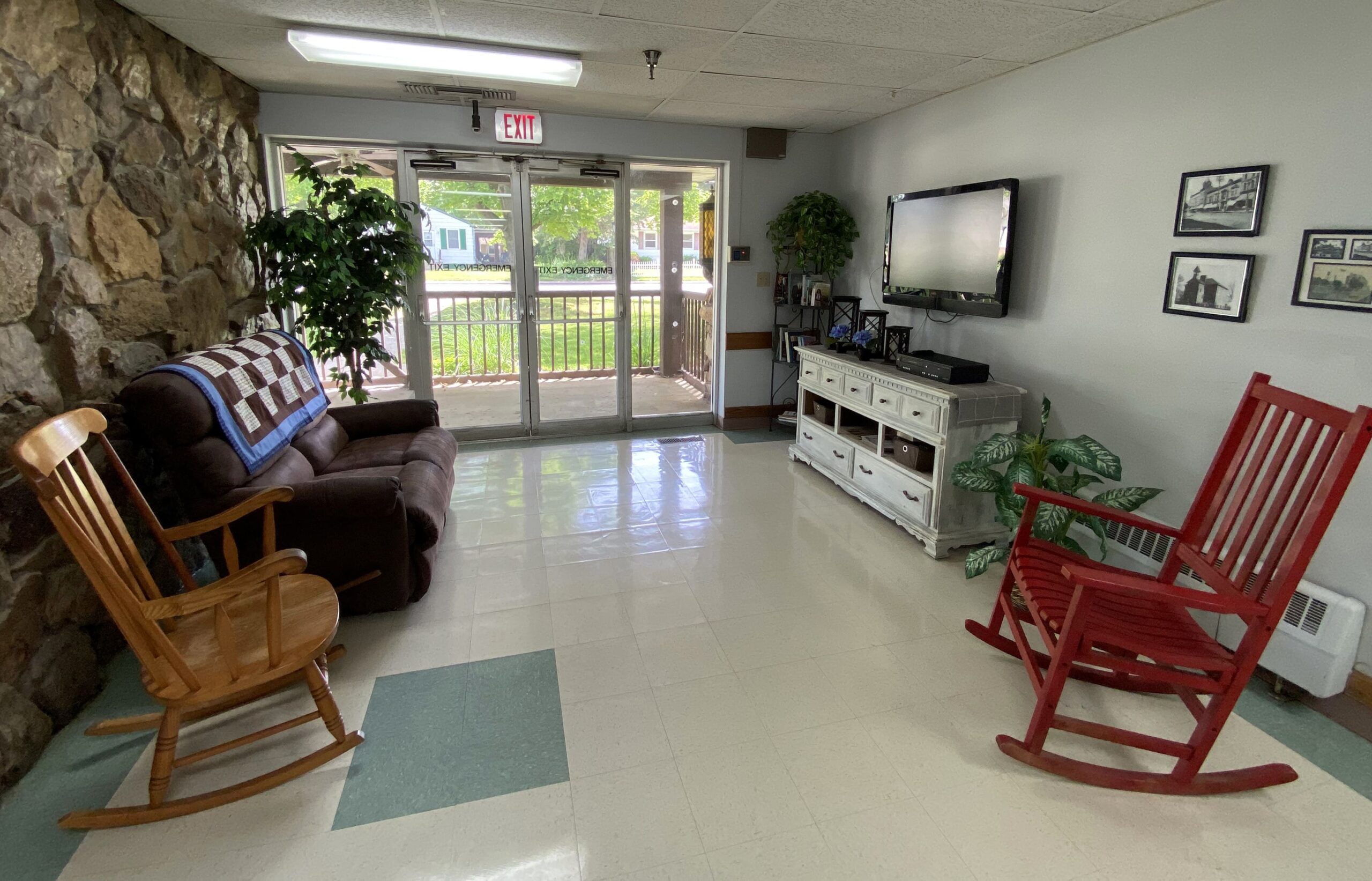 Brickyard Healthcare LaPorte Care Center sitting area with TV and rocking chairs