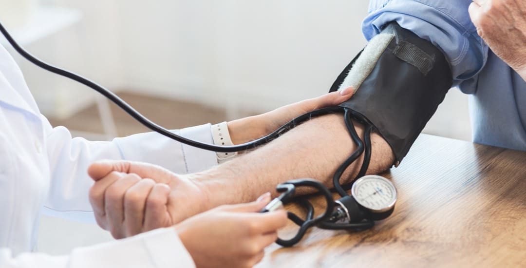 Close-up of a nurse taking a patient's heart rate.