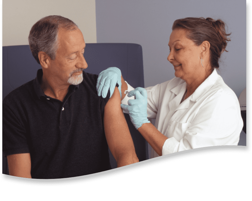 A nurse treats a patient after receiving a shot.