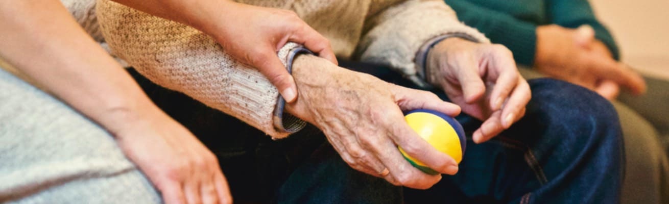 Close-up image of resident's hands in physical therapy activity.