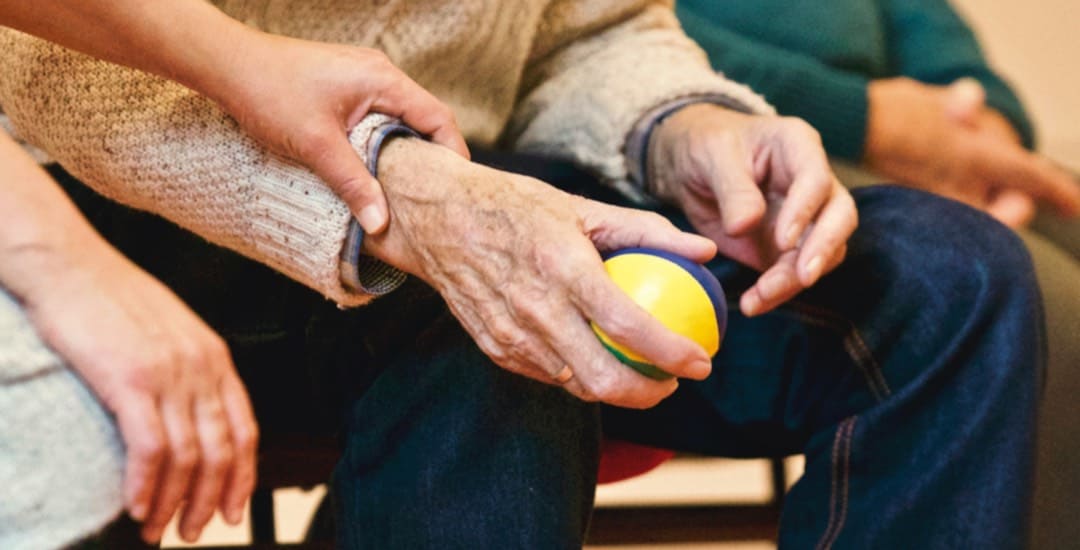 Close-up image of resident's hands in physical therapy activity.