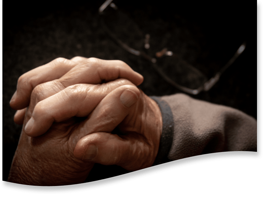 A patient and caregiver holding hands.